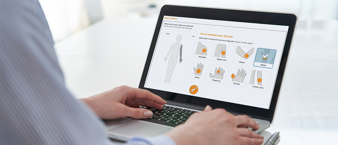 Photo of open laptop with screen showing diagram of injury locations